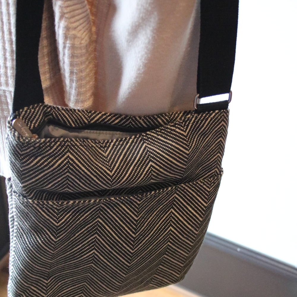 Black and cream thirty one cross body purse.